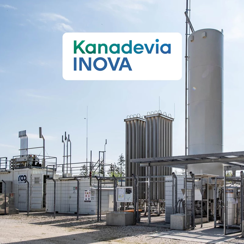 Kanadevia Inova logo in front of a warehouse with blue sky
