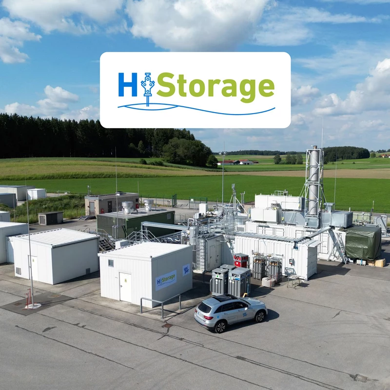 HyStorage logo above the storage facility from above in front of a green meadow